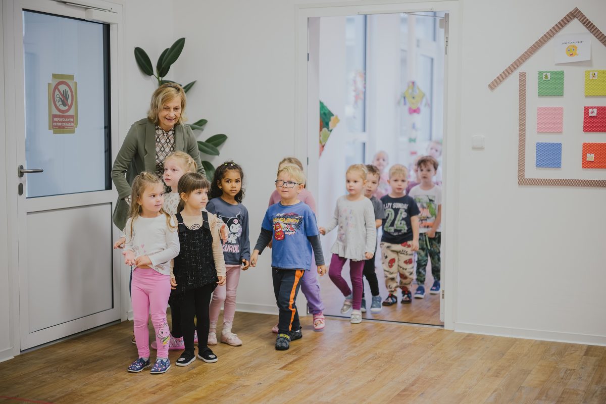 Učitelka vede skupinu dětí do nové mateřské školy Zavadilka v Jaroměři.